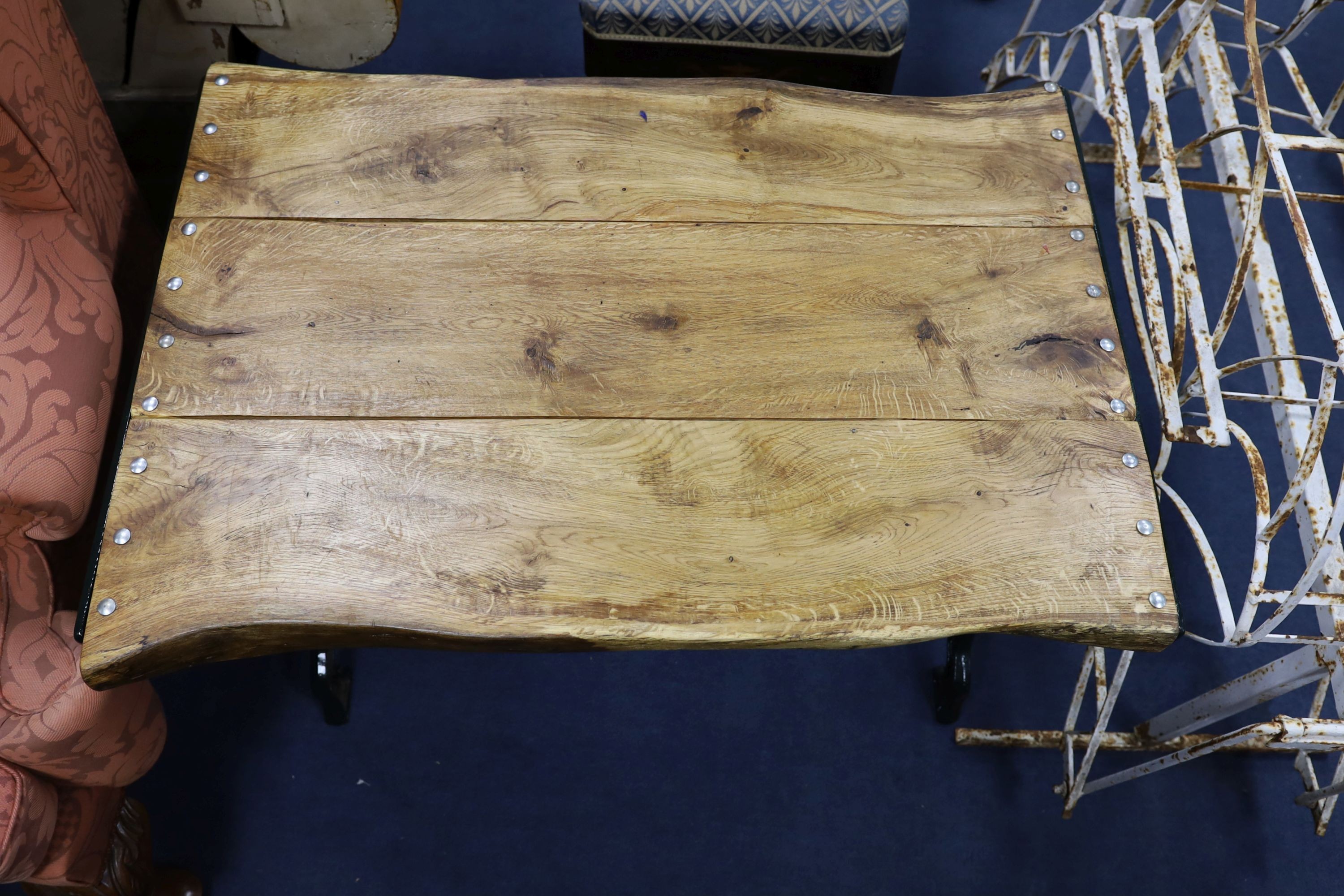 A Victorian style painted cast iron garden table with waney edge top, width 102cm, depth 70cm, height 68cm